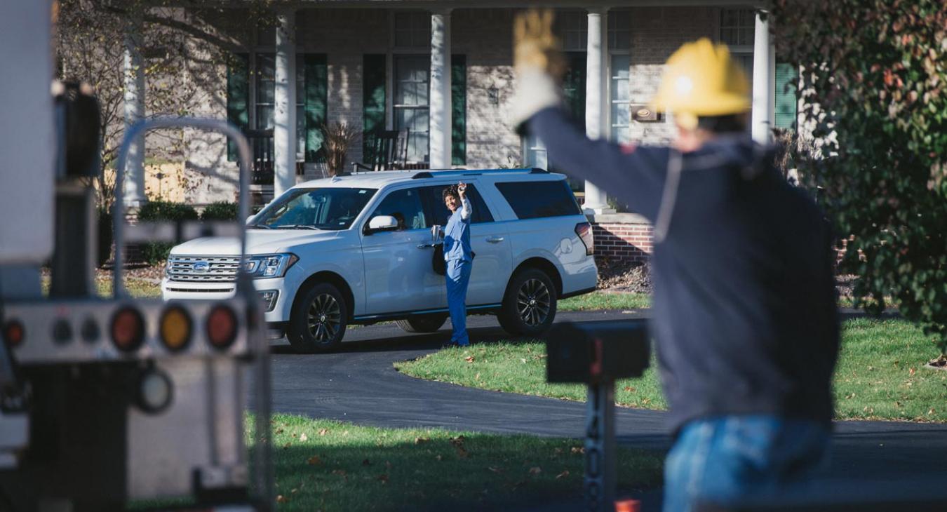 Co-op Employee Waving to Member