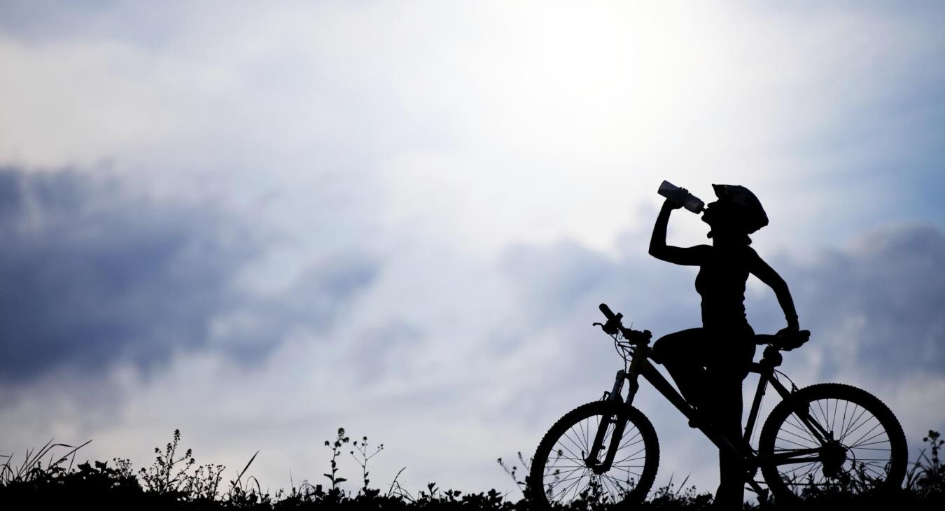 Bicycle rider drinks water